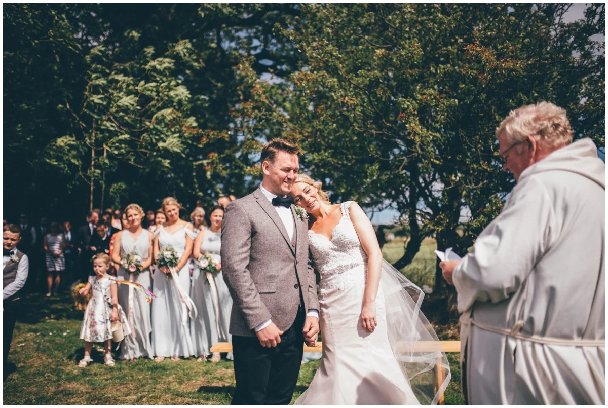 Wedding blessing in a sunny field in summer.