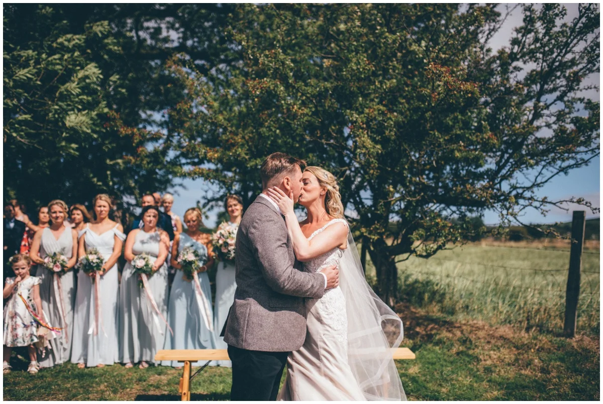 Wedding blessing in a sunny field in summer.