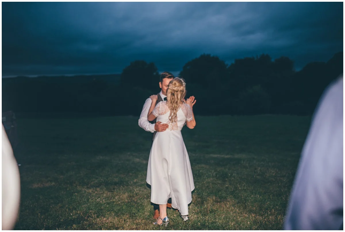 Bride and groom have their First Dance outside their wedding tipi in Staffordshire.