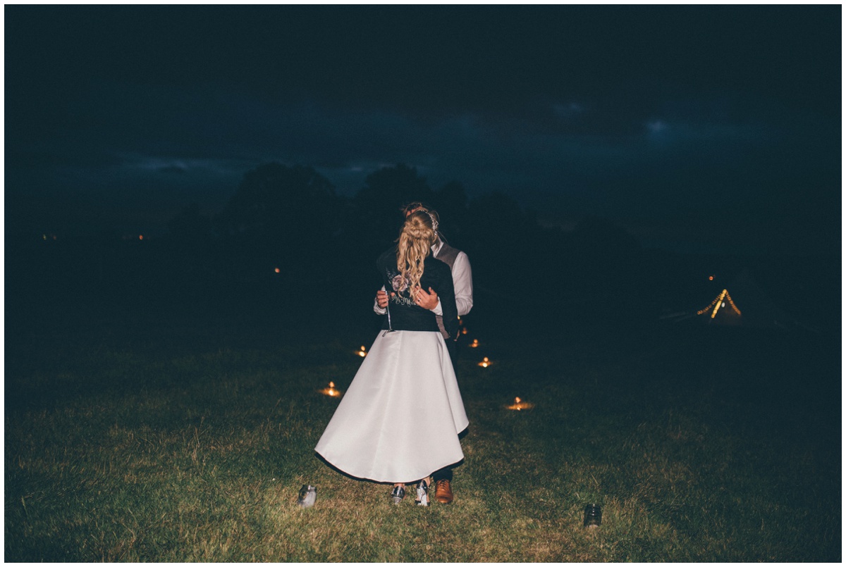 Bride and groom enjoy their evening reception at their tipi wedding in Staffordshire.
