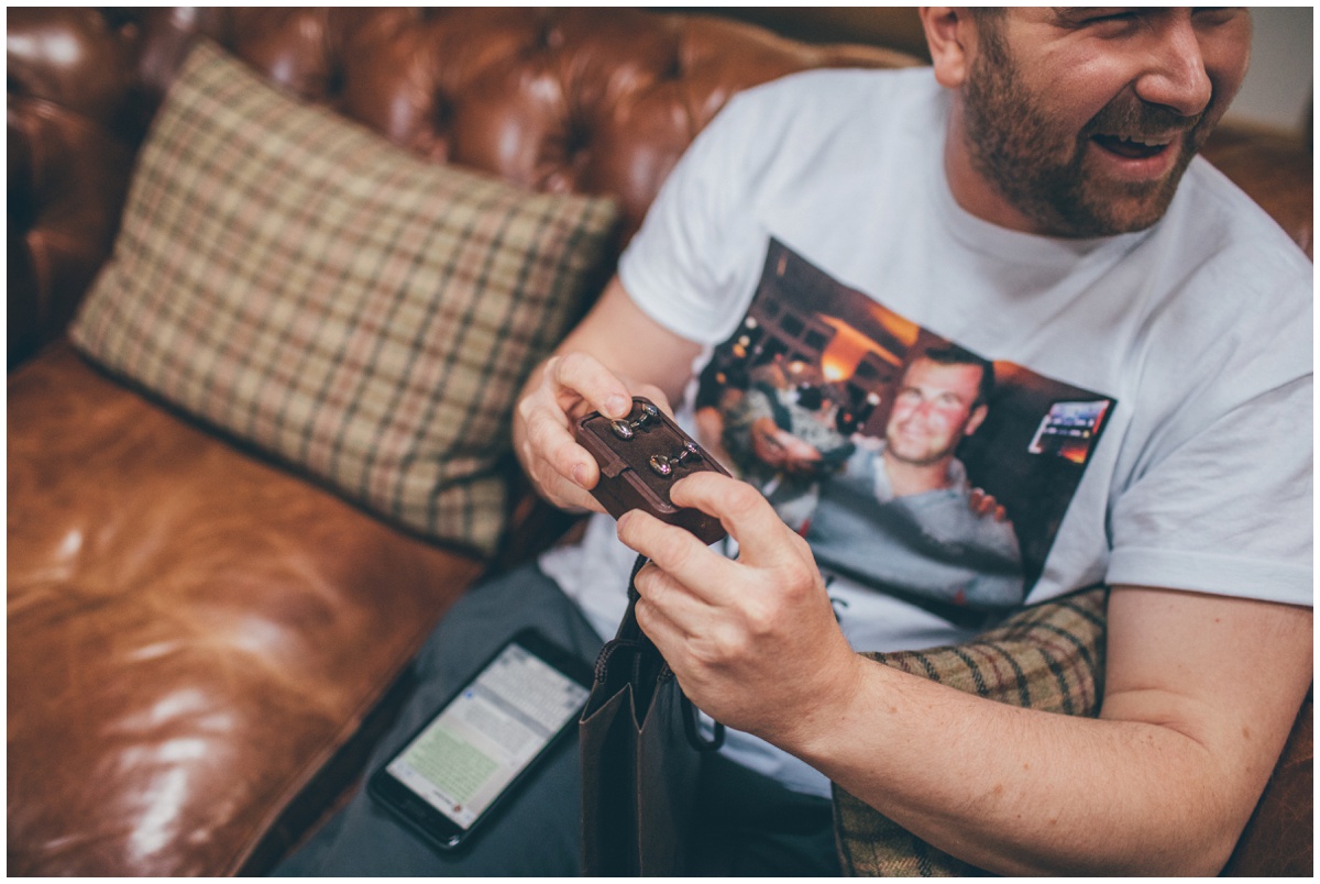 Groomsman gets given some cufflinks on the wedding morning as a gift.