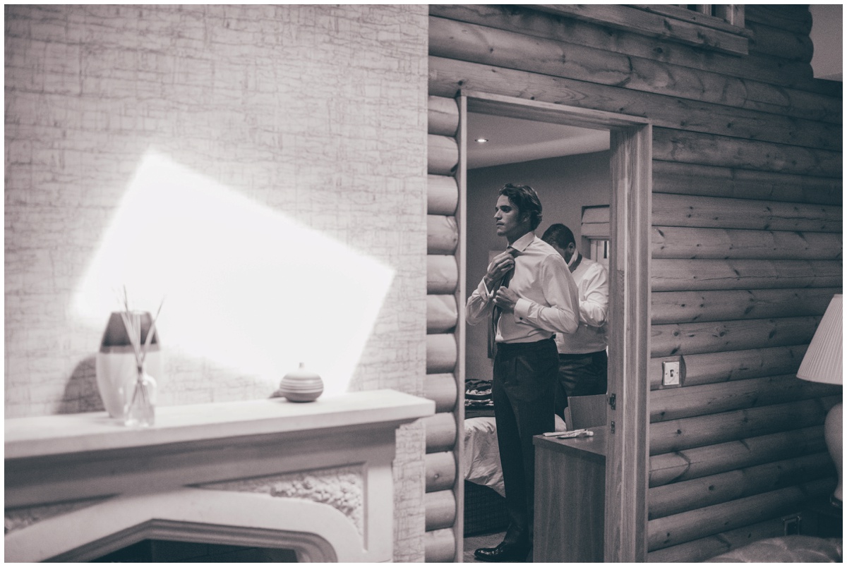 Groomsmen get ready on the wedding morning at log cabins in Delamere Forest.