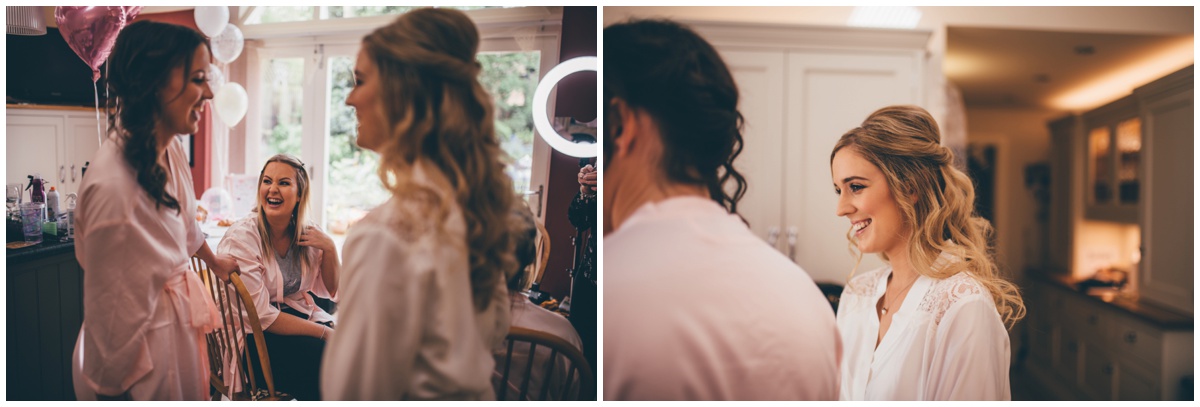 Bride laughing with her bridesmaids on the morning of her wedding.