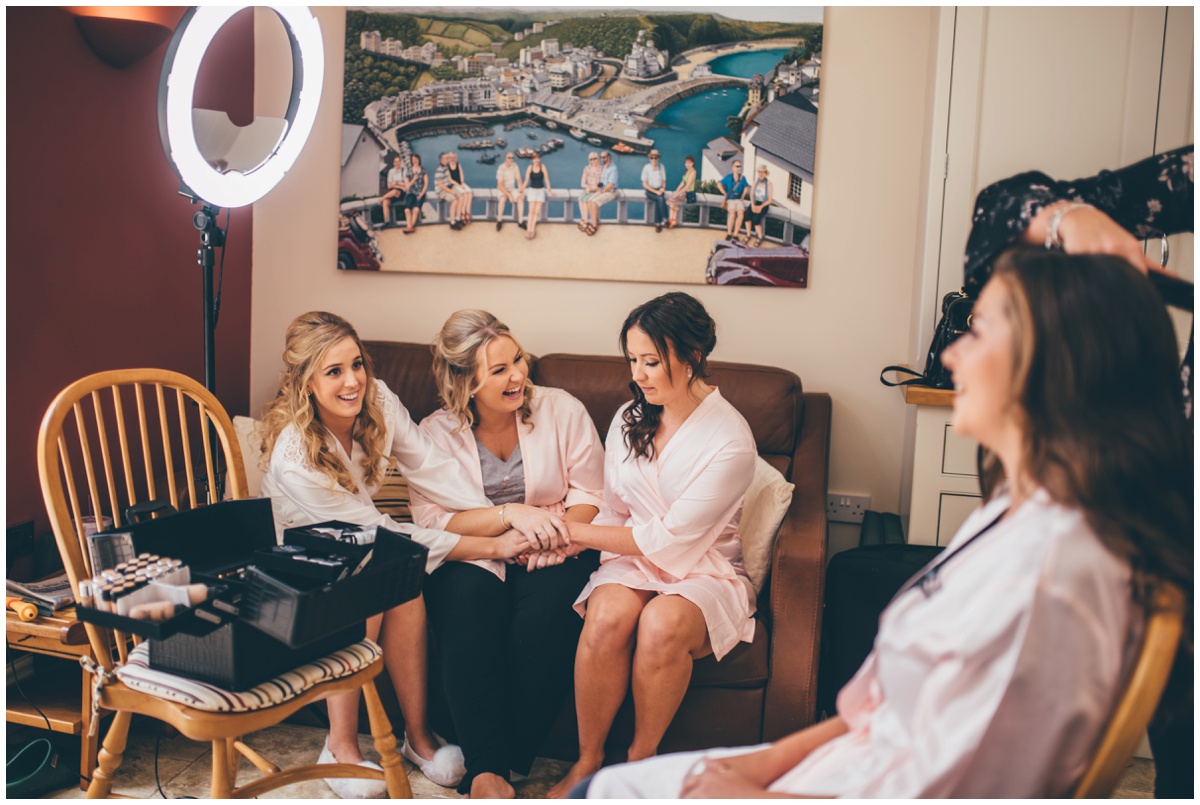 Bride jokes with her bridesmaids on the wedding morning in Cheshire.