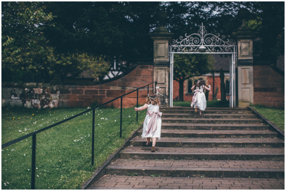 Adorable little flowergirls run into St Mary's church in Cheshire ahead of the bride.