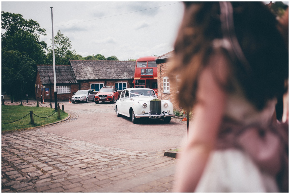 The bride arriving at St Mary's church in Cheshire in a vintage wedding car.