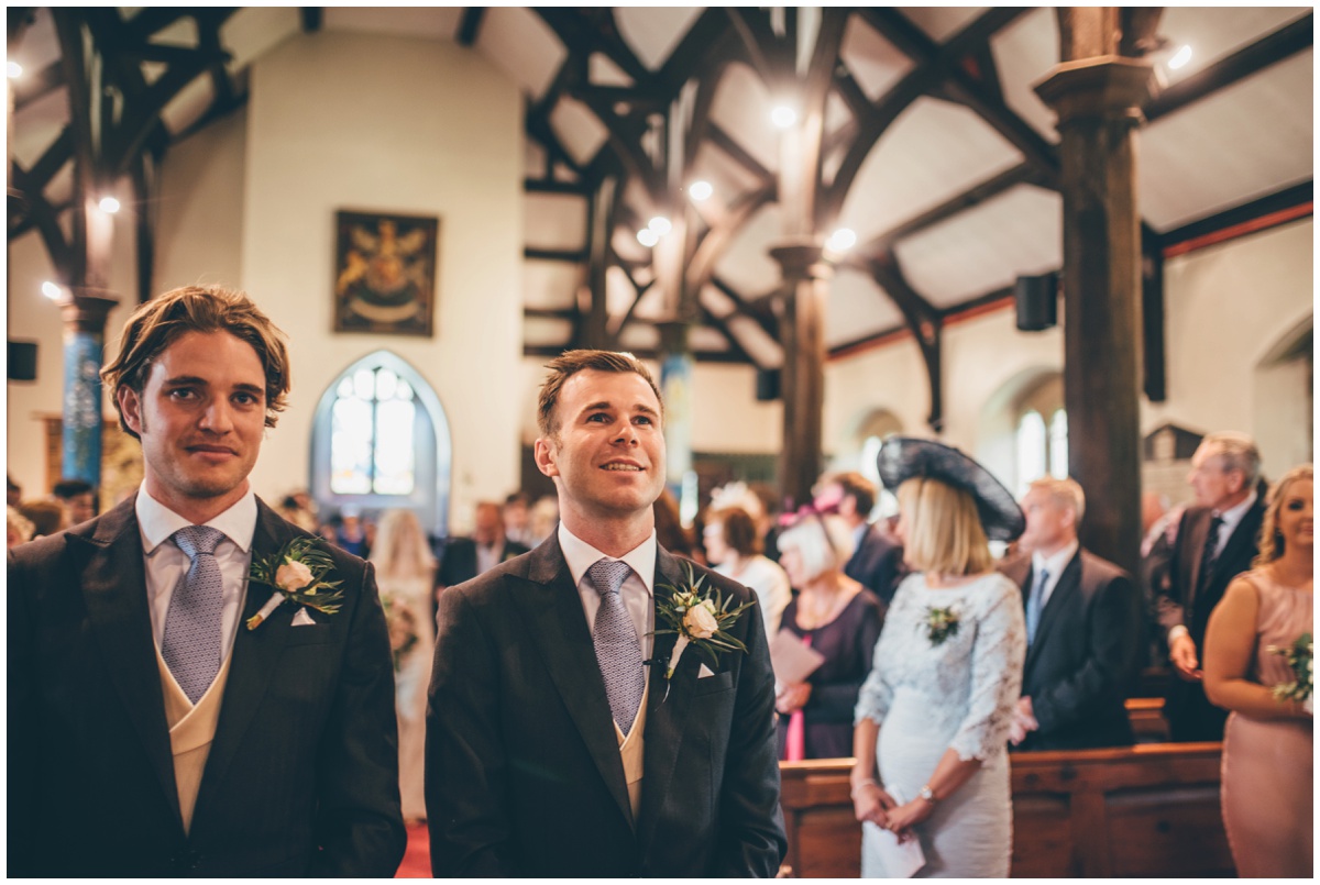 Groom and Best Man wait for the bride to arrive in St Mary's Church in Cheshire.