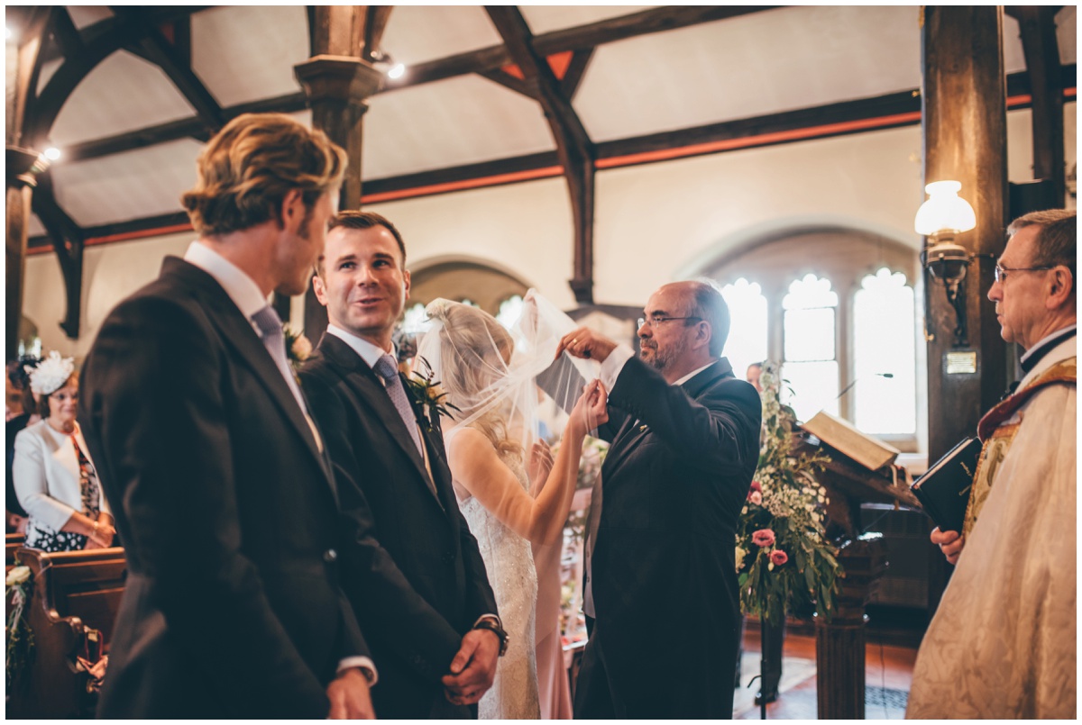 Groom and Best Man wait for the bride to arrive in St Mary's Church in Cheshire.