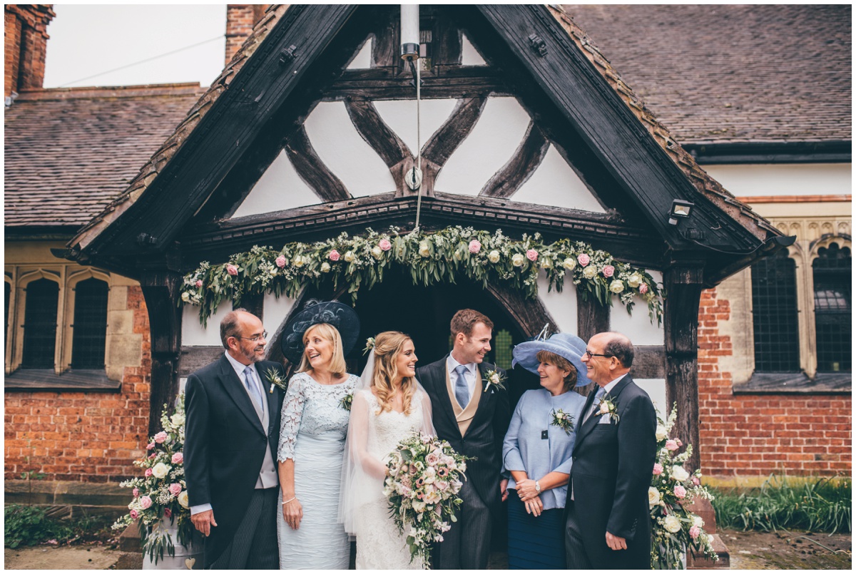 The newlyweds pose with their in-laws outside St Mary's Church in Cheshire.