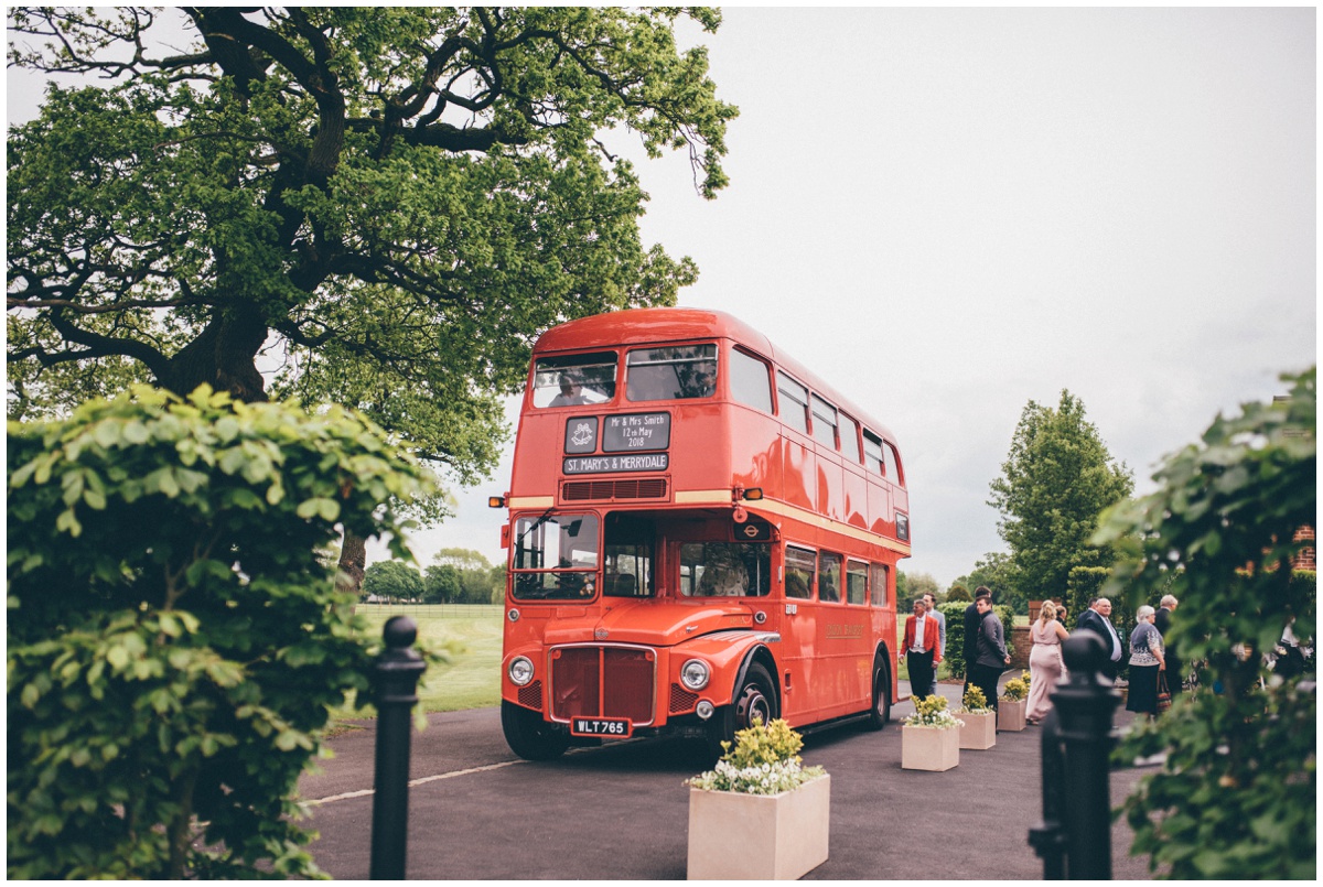 The guests arrive to the wedding at Merrydale Manor in a double decker red bus.