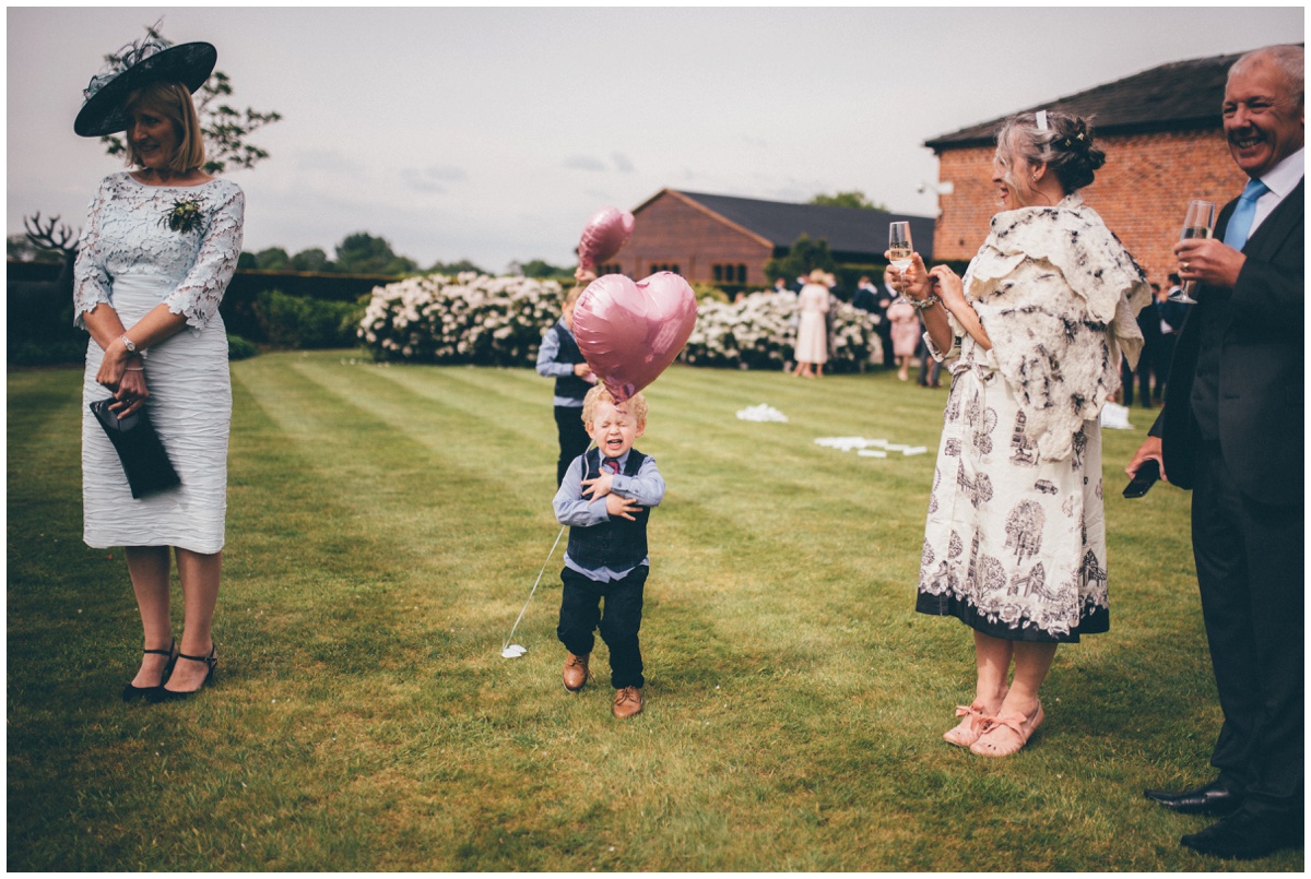 Cute little boy runs at helium balloon at Merrydale Manor.