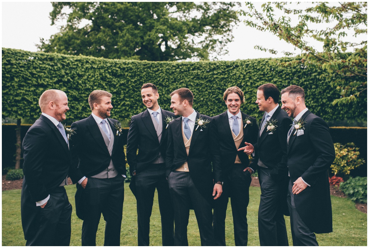 Groomsmen all share a joke in the grounds of Merrydale Manor.