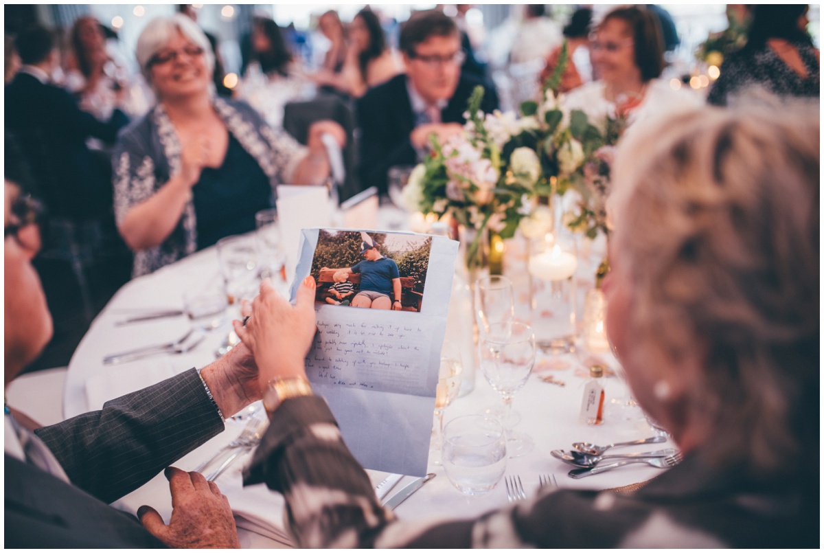 Wedding guests look at their favours.