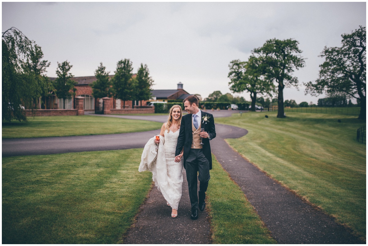Bride and groom walk around their wedding venue, Merrydale Manor.