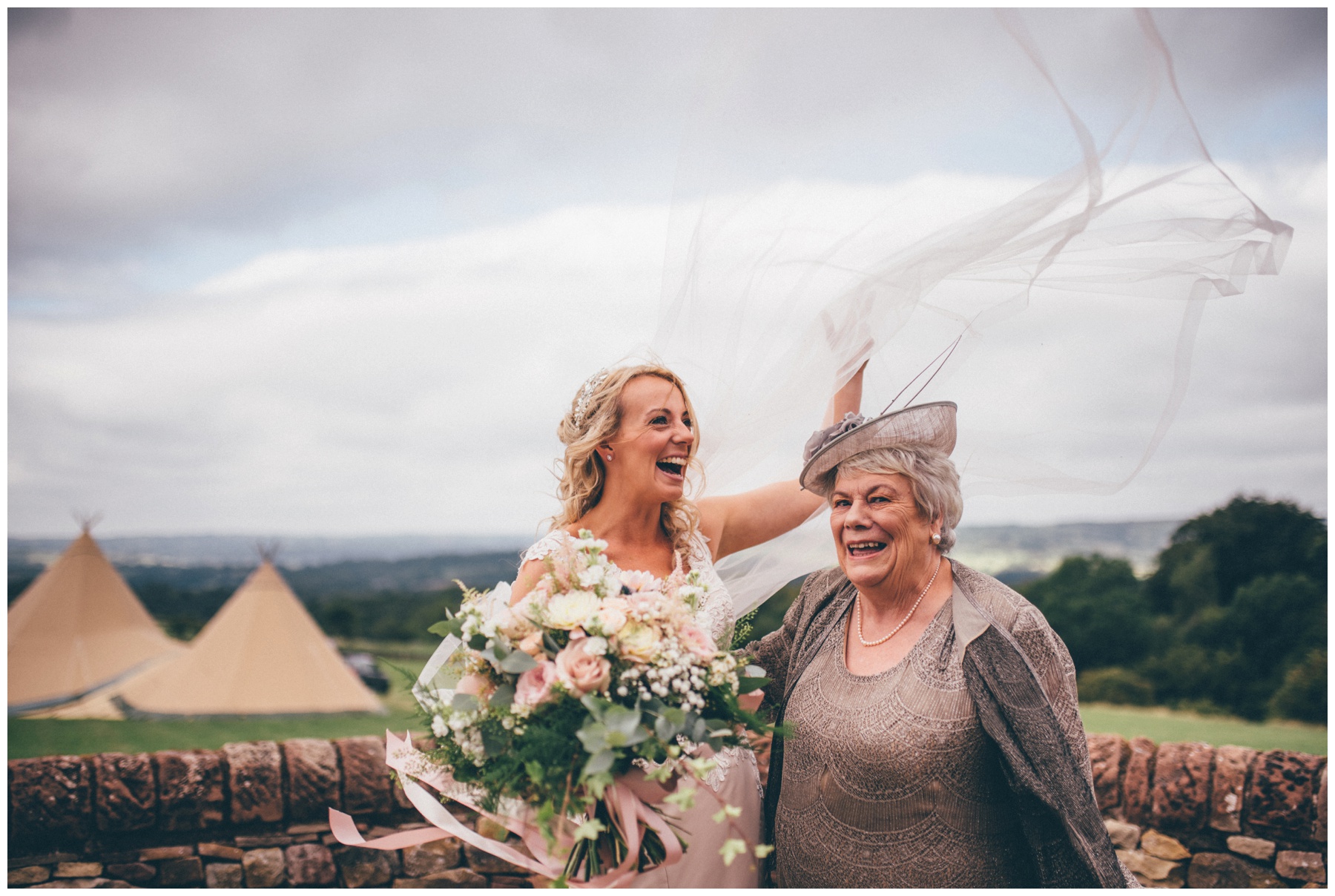 Bride loses he veil whilst stood with her mum before her tipi wedding in Staffordshire.