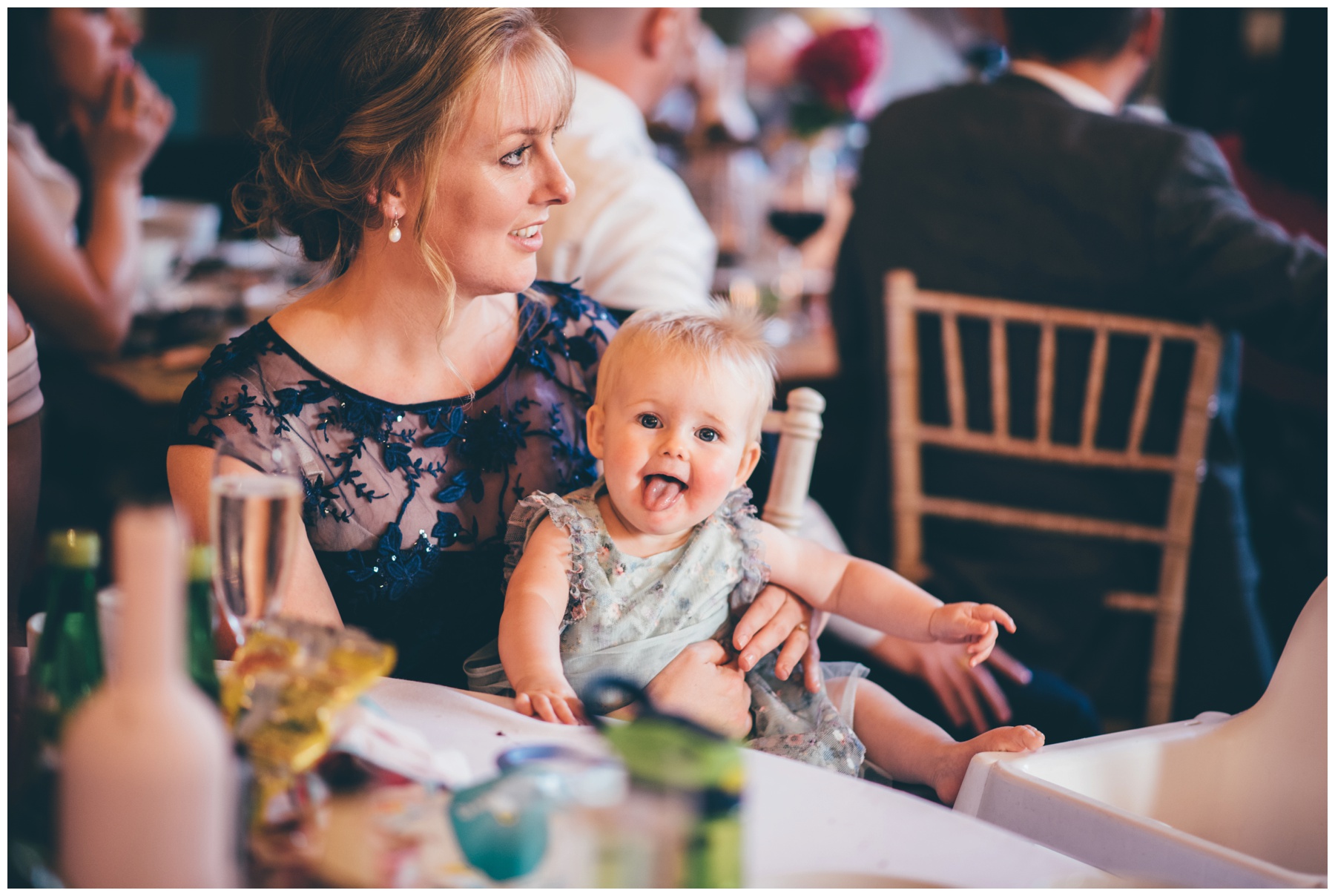 Cute little wedding guest enjoys cake during the wedding speeches.