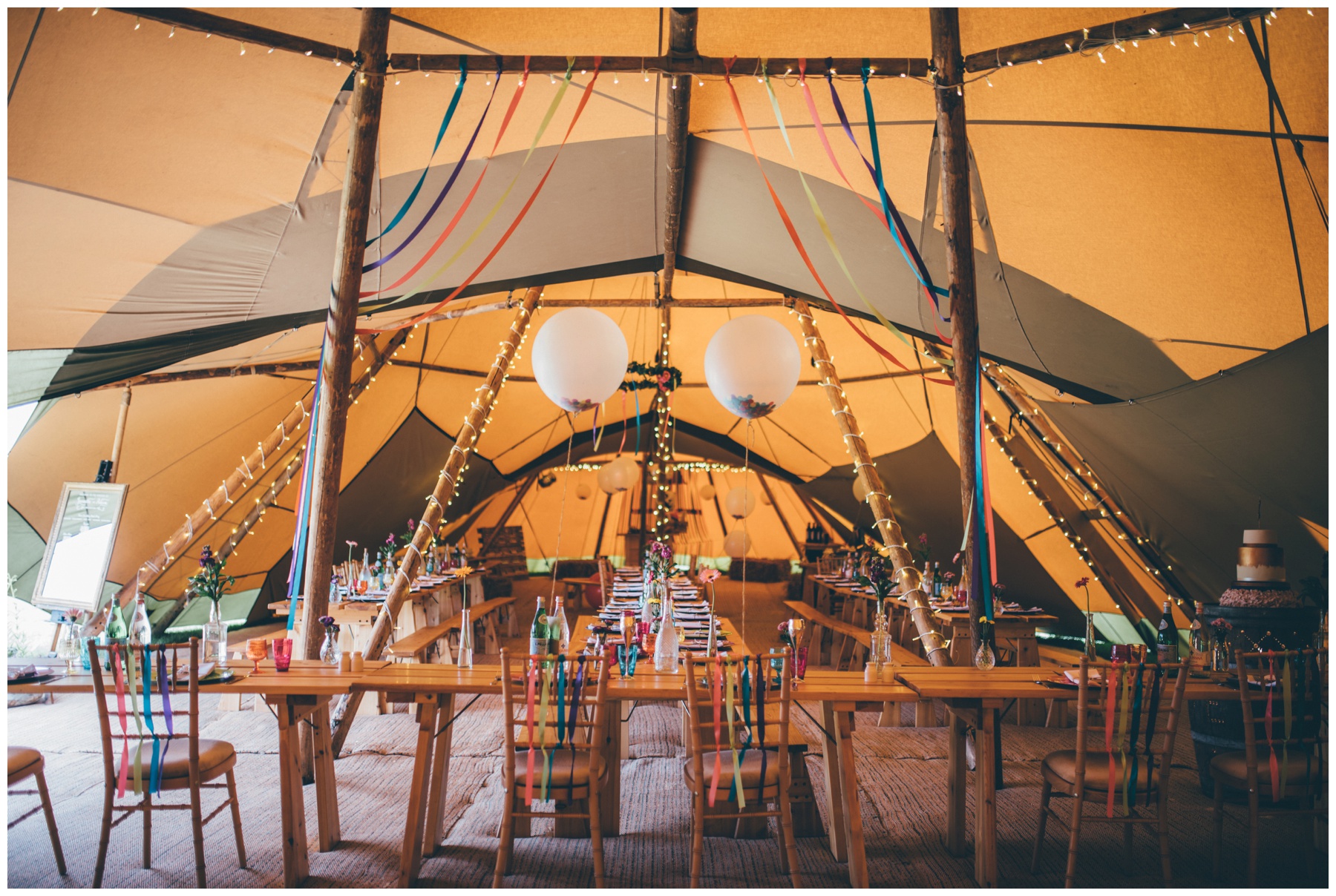 Stunning and brightly colourful interior of tipi in Staffordshire wedding.