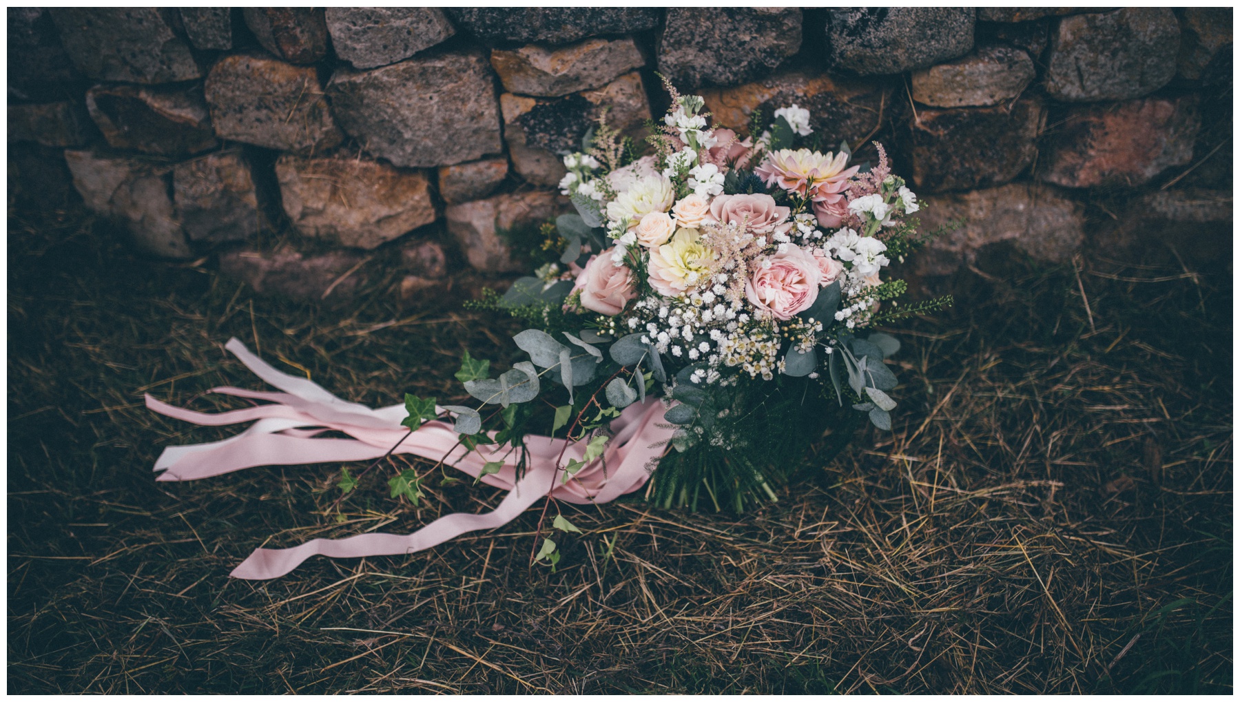 Stunning pastel bridal bouquet with ribbons.