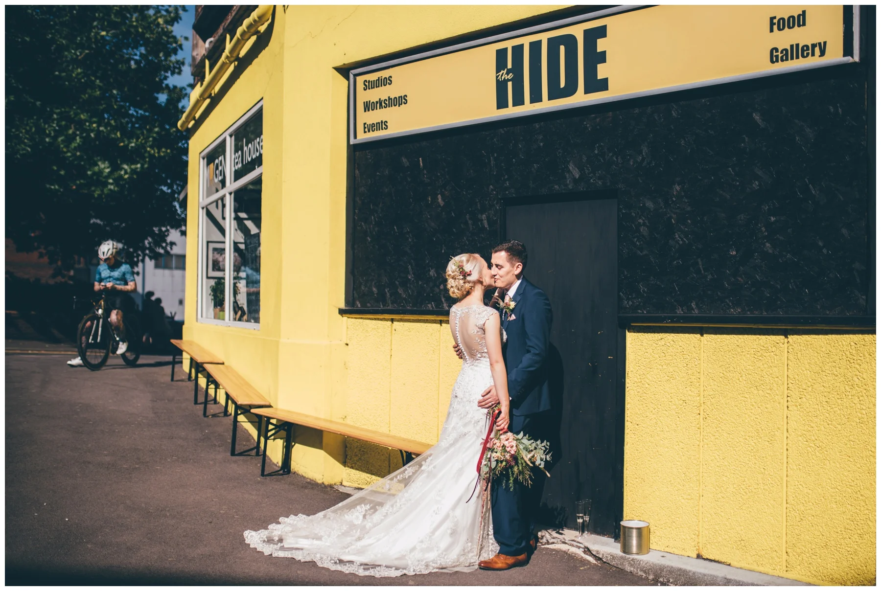 Bride and groom share a kiss outside their colourful city centre wedding venue, The Hide in Sheffield.