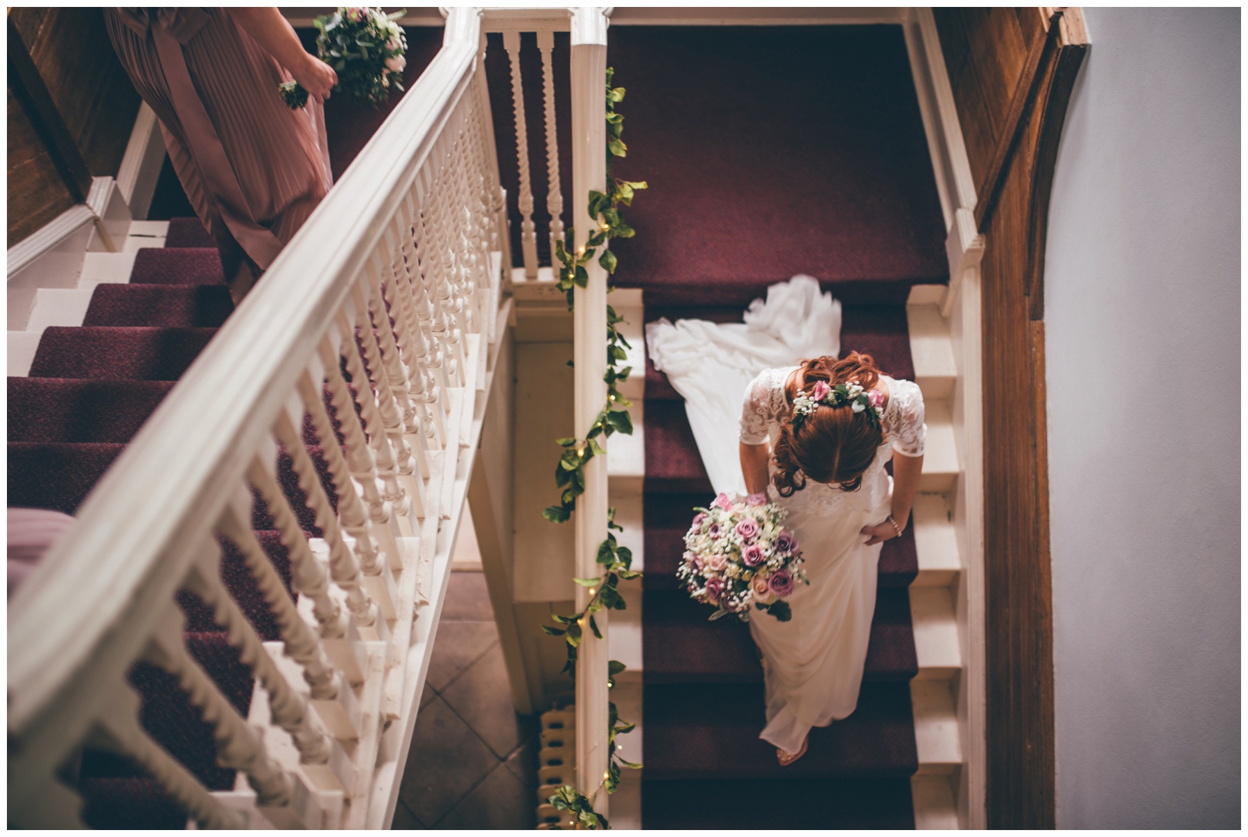 Bride walks down the stairs of Cheshire wedding venue, Trafford Hall, on the way to her wedding ceremony.