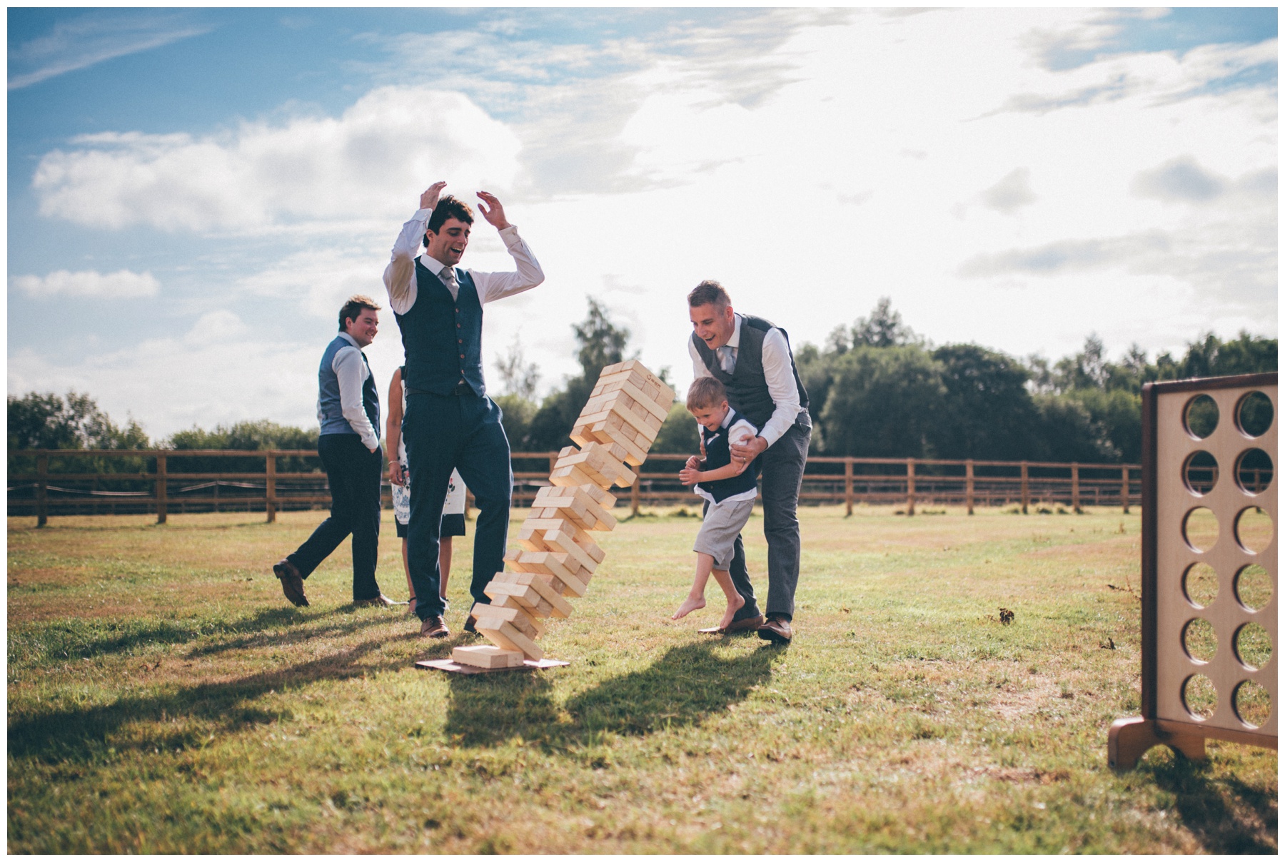 The jenga falls at over in summer lawn games at Holford Estate wedding in Cheshire. 