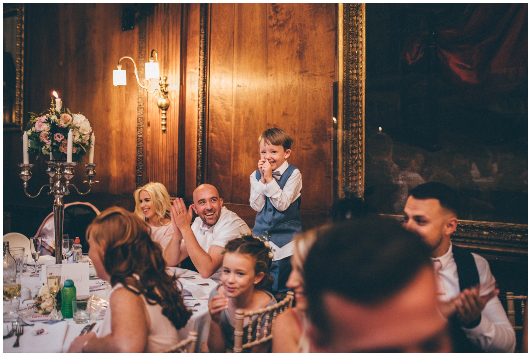 Adorable being little wedding guest gets a round of applause during the speeches at Thornton Manor on the Wirral.