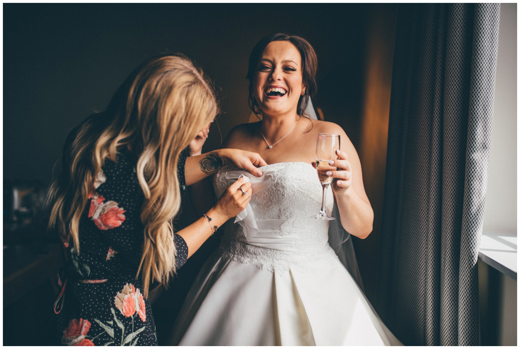 Bride hysterically laughs as the Wirral Make Up Artist wipes her dress clean at the  Titanic Hotel in Liverpool City Centre.