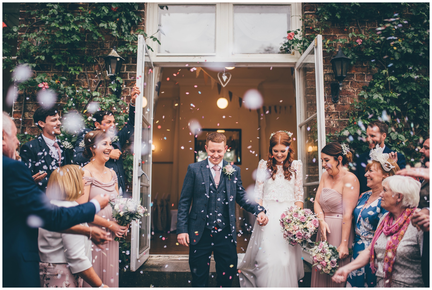 Bride and groom get beautiful confetti thrown at them at Trafford Hall.