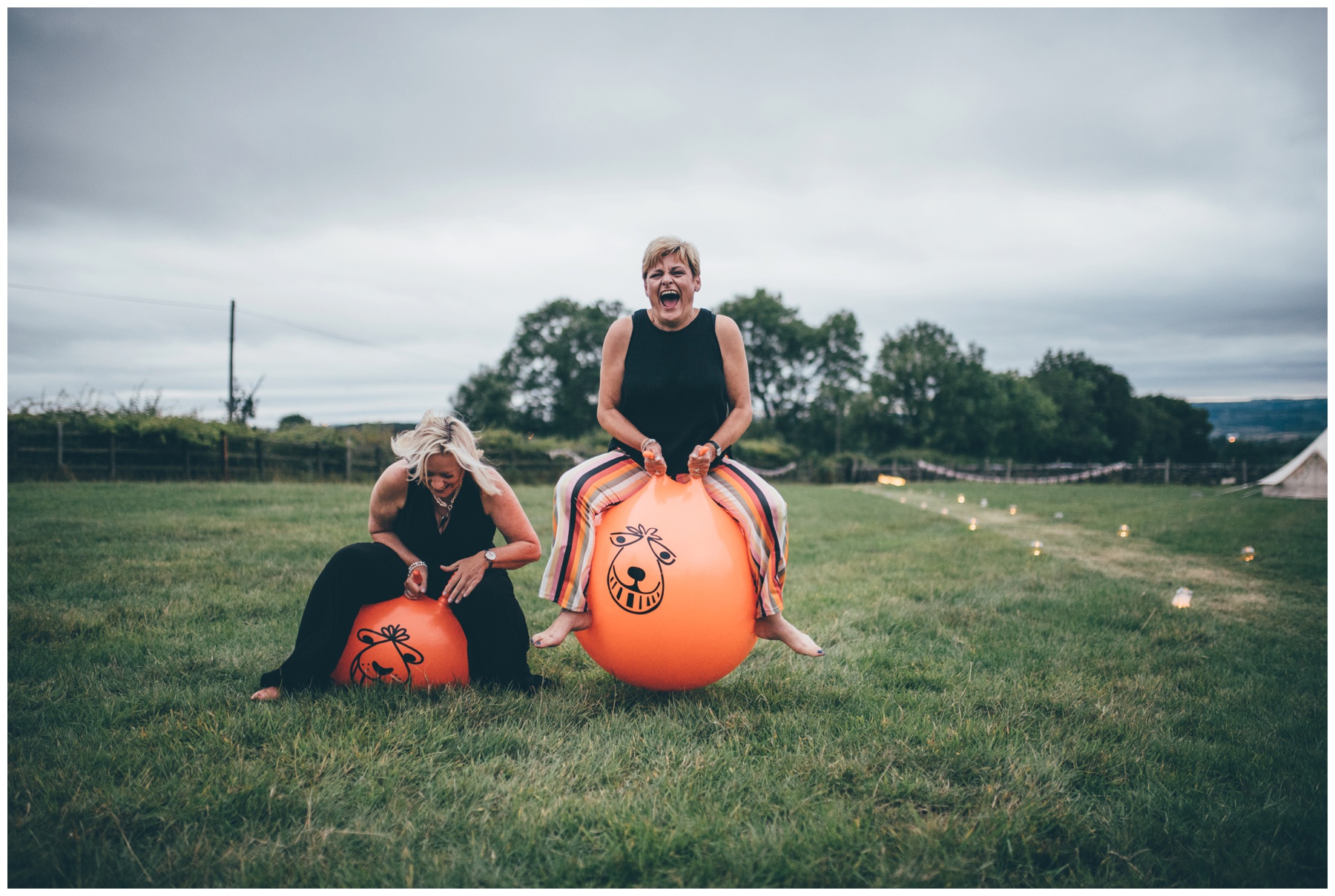 Wedding guests enjoy space hoppers at tipi wedding in Staffordshire.