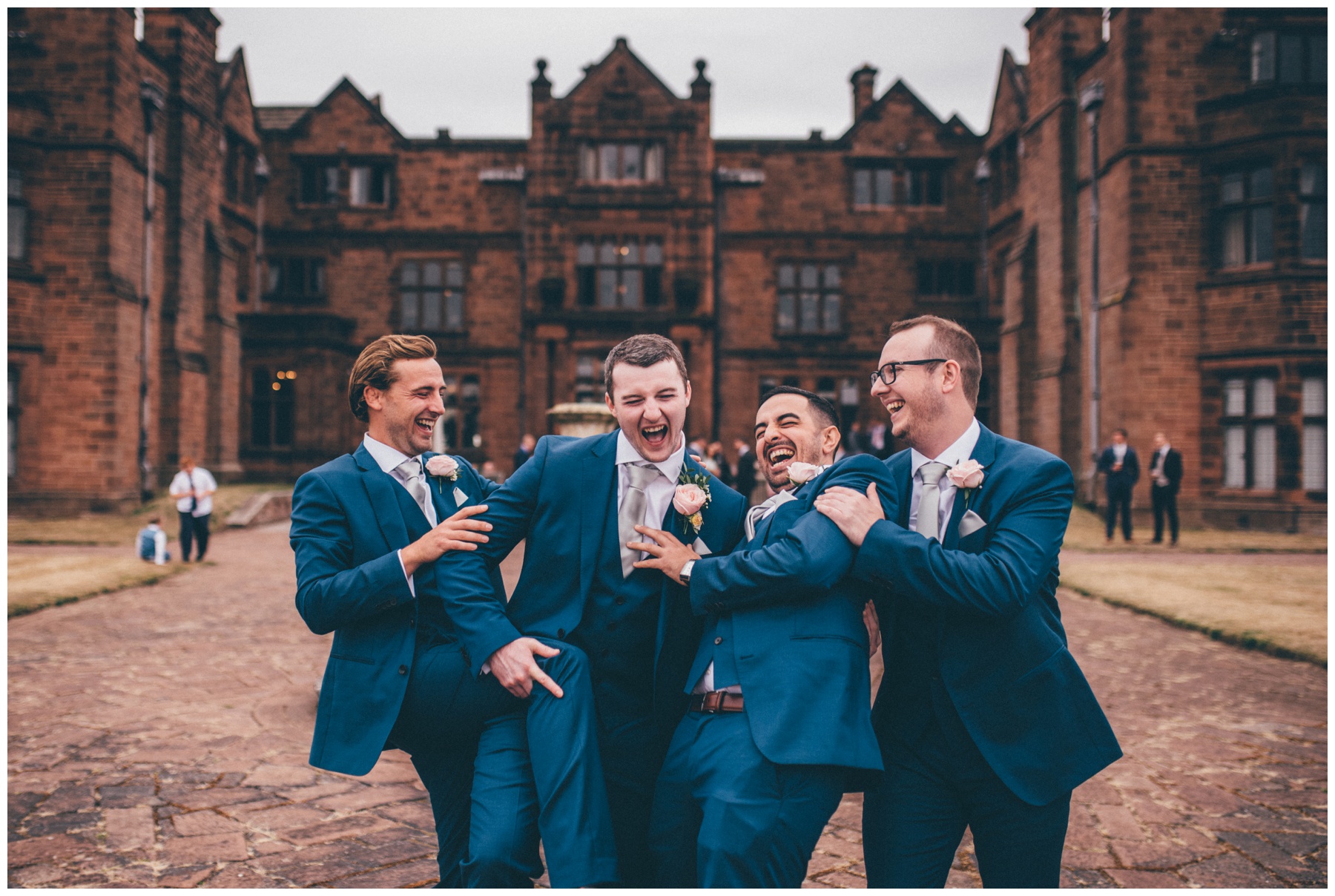 Groomsmen and the groom have fun at Thornton Manor wedding in the summer.
