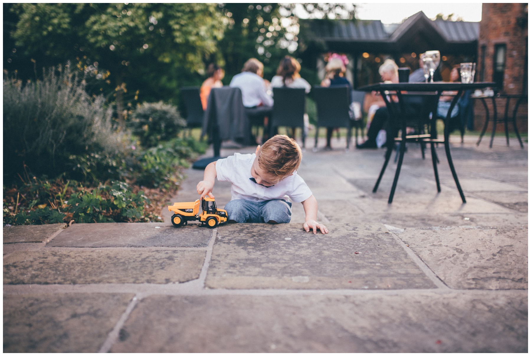 Cute little wedding guest plays with his truck at Crabwall Manor wedding.