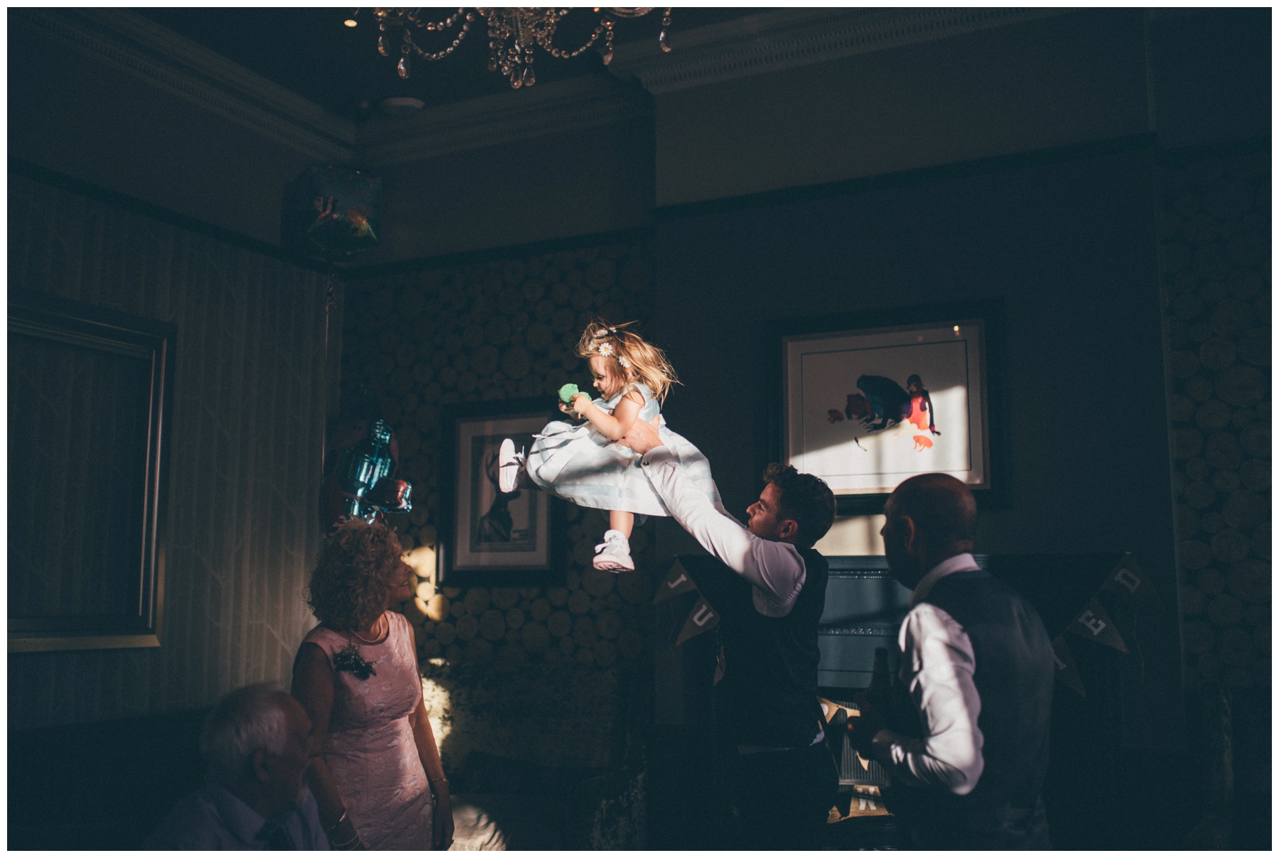 Flowergirl gets thrown in the air by a wedding guest at Oddfellows in Chester.