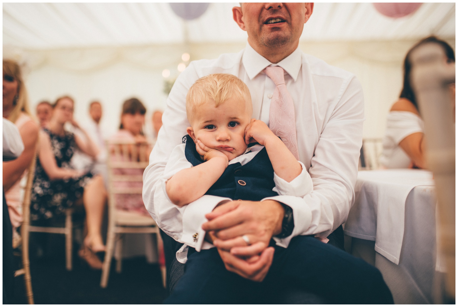 Adorable little wedding venue looks incredibly bored during the wedding speeches at Nunsmere Hall.