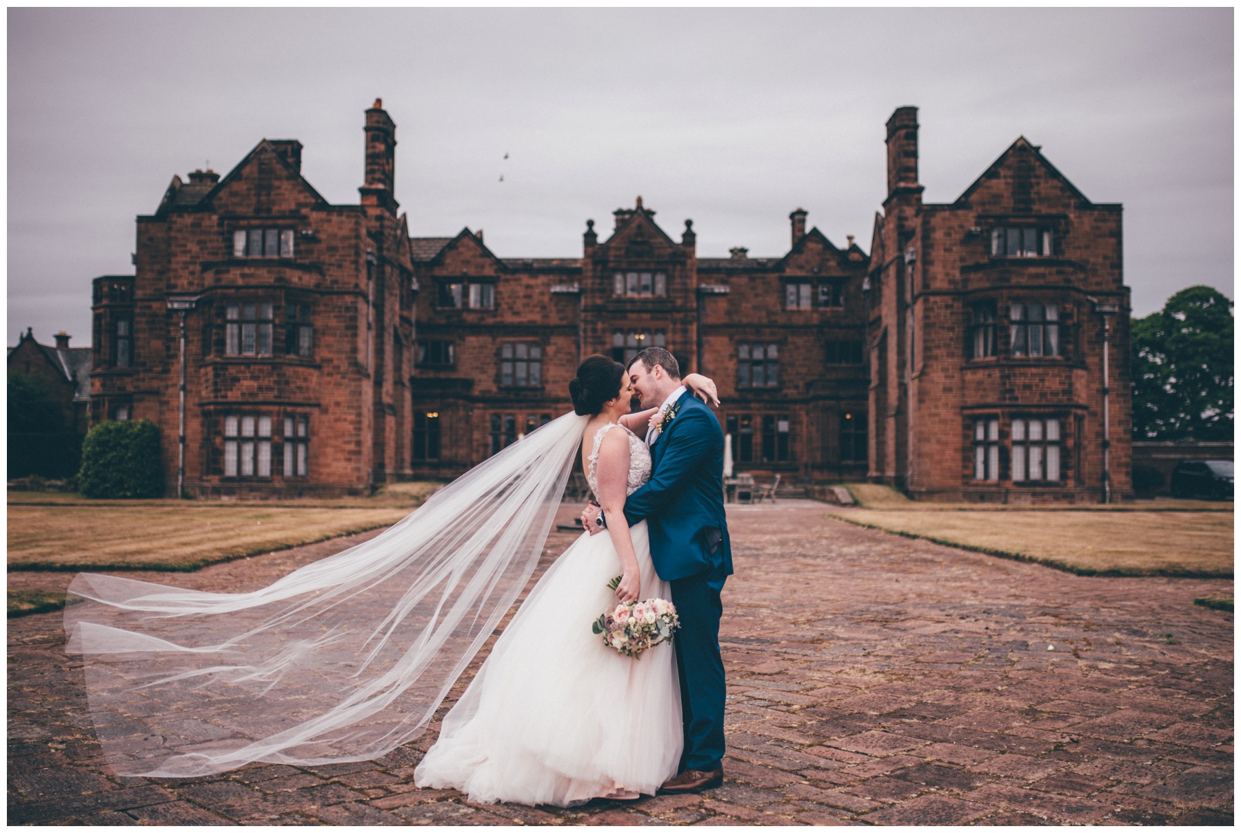 Stunning veil blowing in the wind at summer wedding at Thornton Manor in Cheshire.