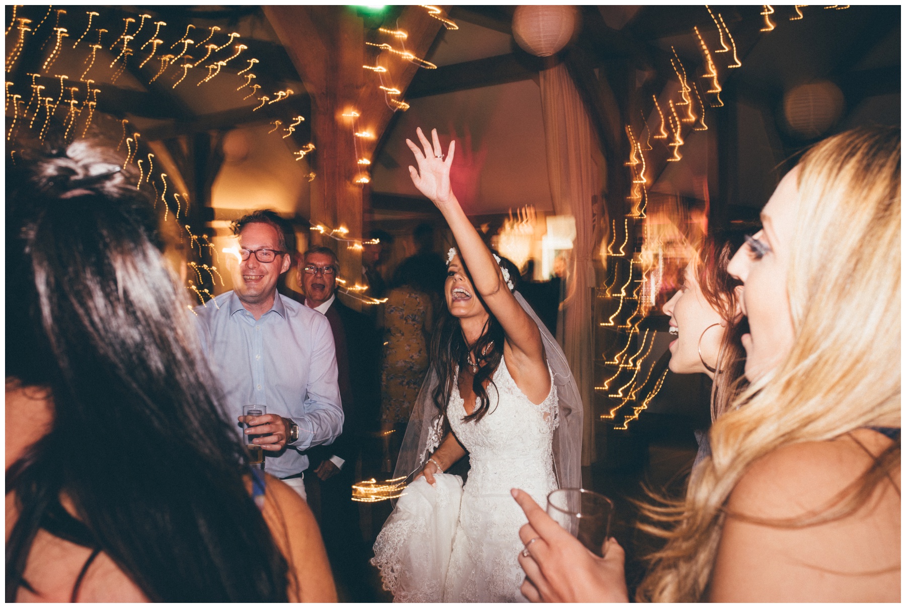 Beautiful bride dances at her wedding at Sandhole Oak Barn in summer wedding in Cheshire.