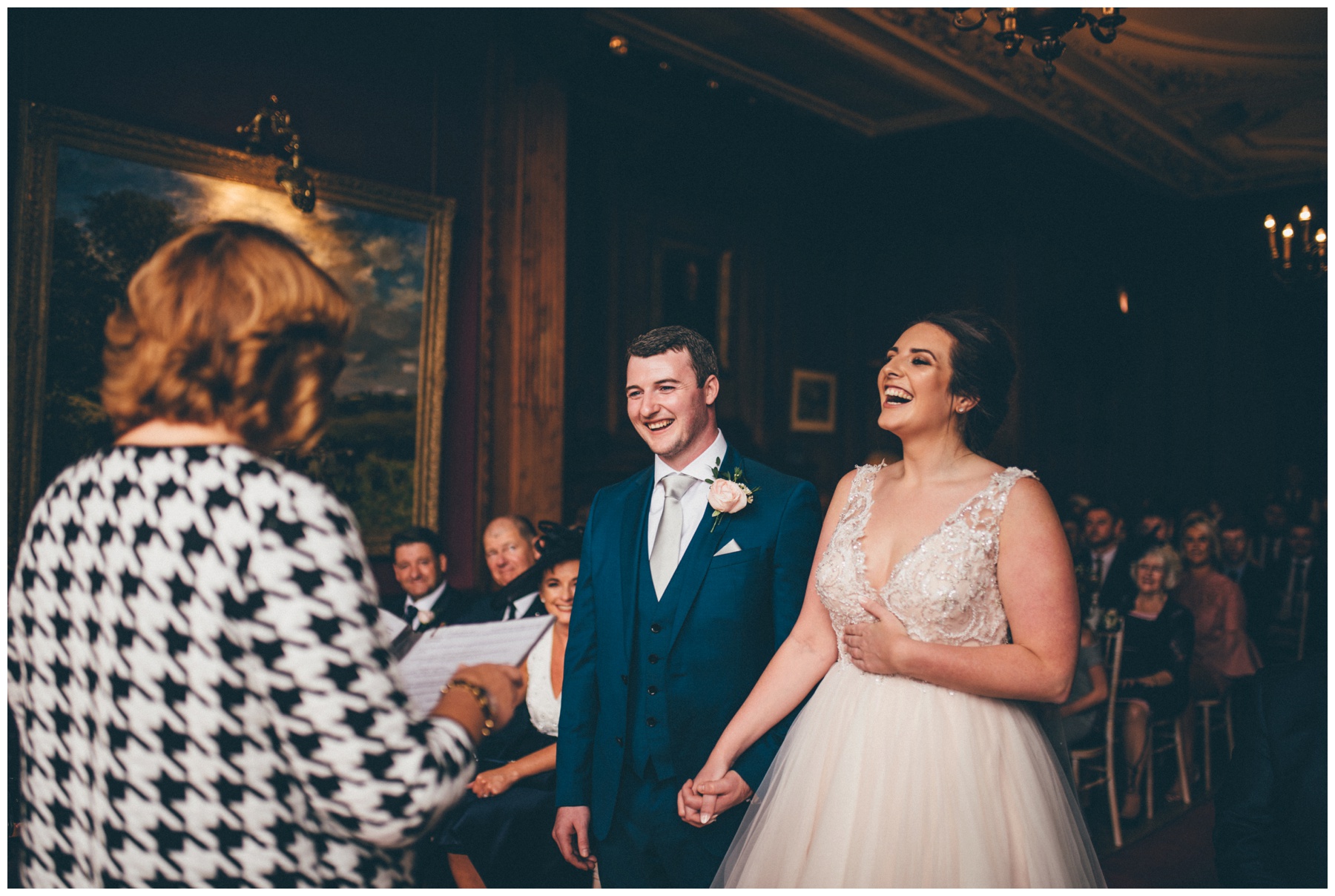 Bride and groom laugh during their wedding ceremony at Thornton Manor.