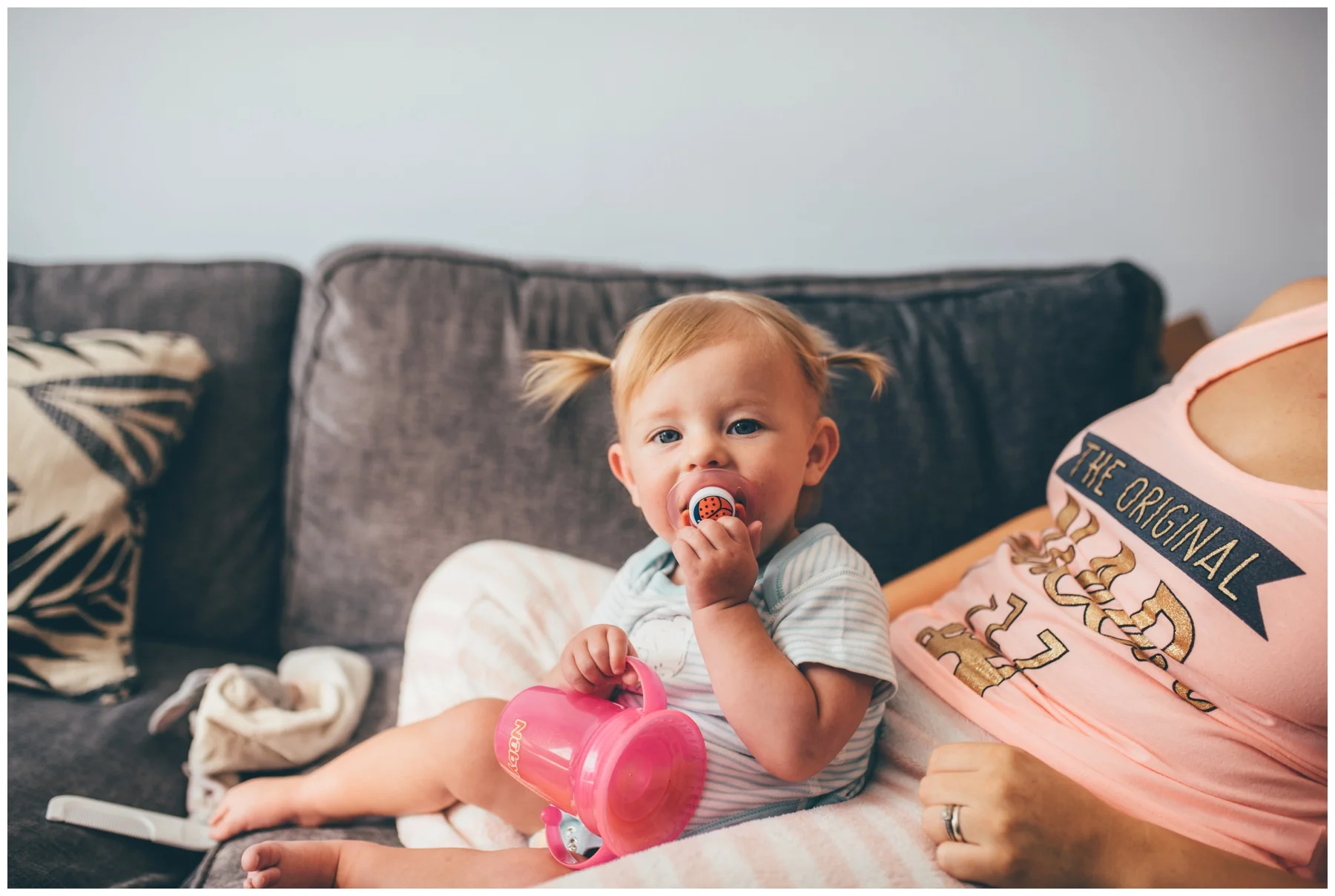 Cute little flower girl gets her hair done into pigtails before the wedding.