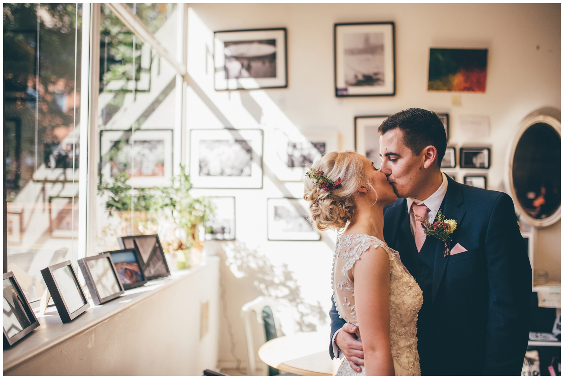 Bride and groom share a kiss in the art gallery of The Hide in Sheffield city centre wedding.