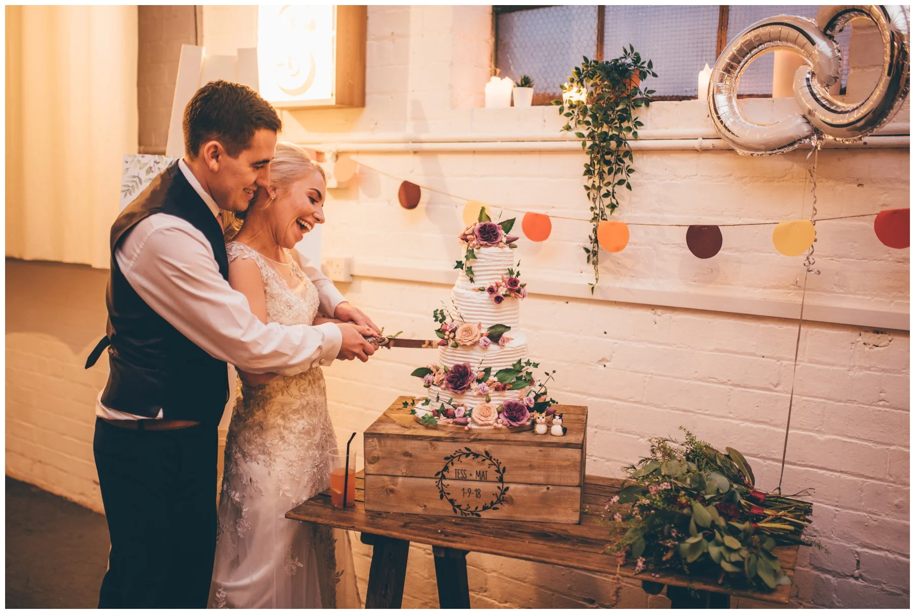 Bride and groom cut their wedding cake at The Hide in Sheffield.
