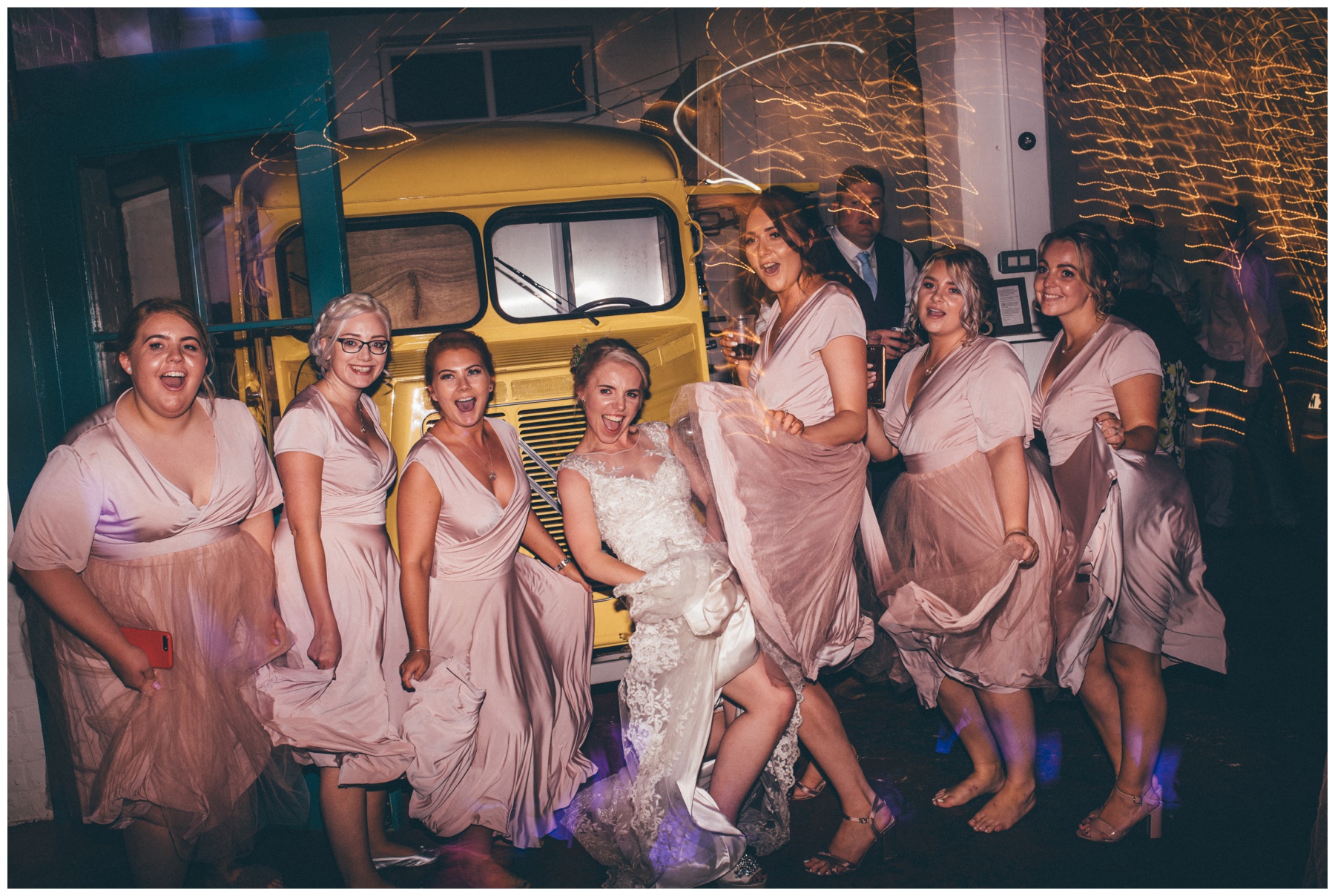 Bridesmaids dance with the bride at The Hide, a cool, Urban wedding venue in Sheffield.