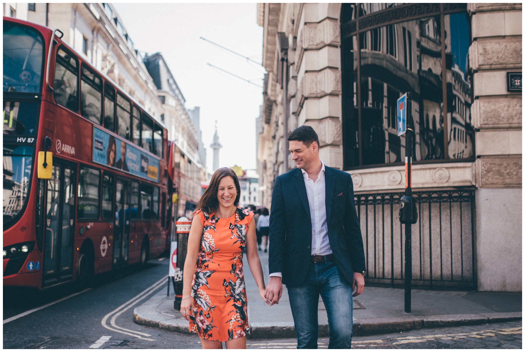 Cute couple stroll through London city centre together for their engagement shoot.