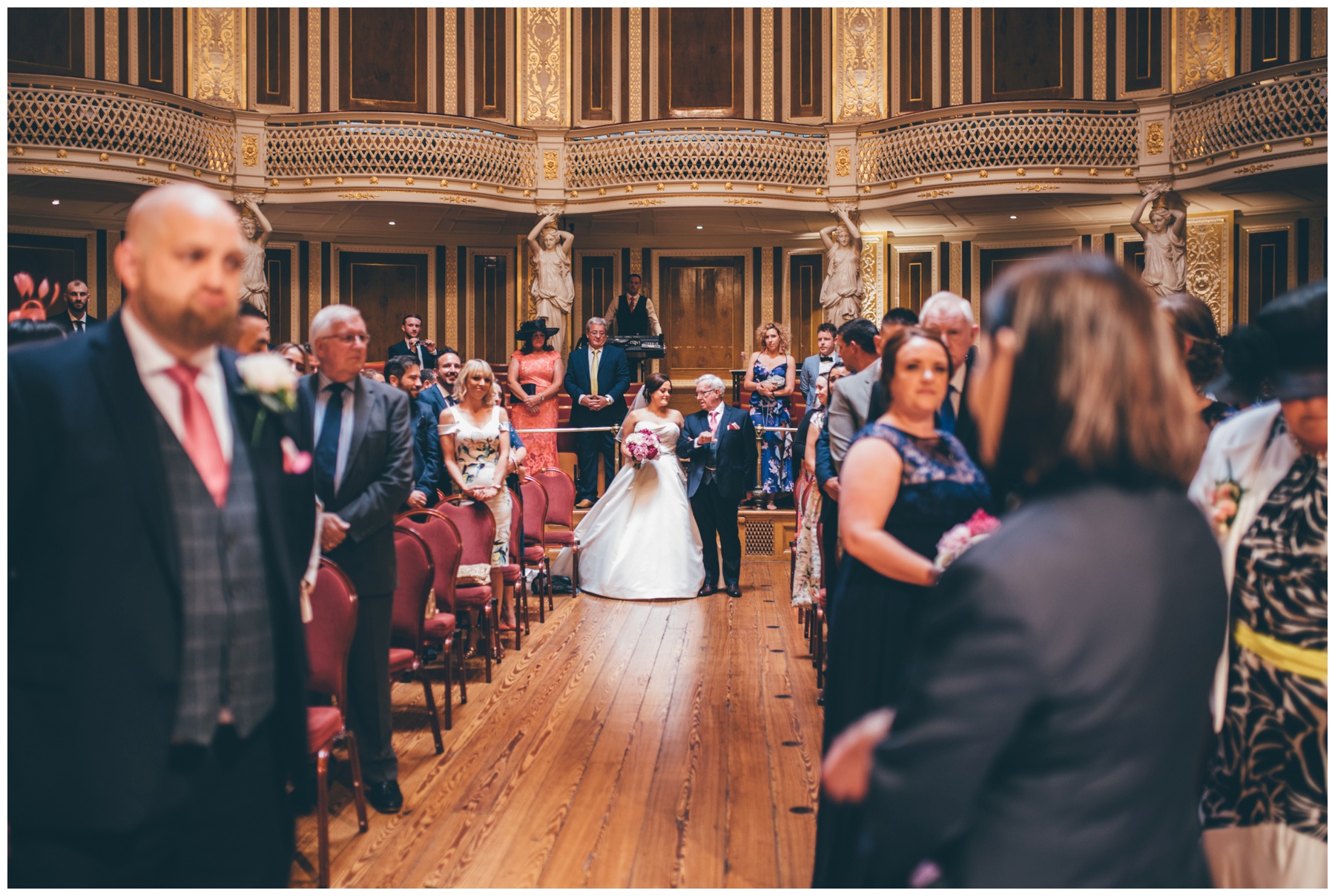 Bride walks downt the aisle St Georges Hall wedding in Liverpool City Centre.