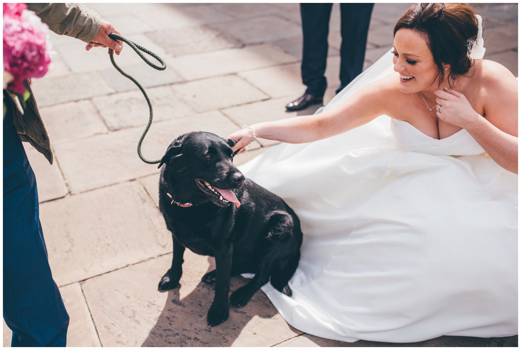 New husband and wife walk their dog in Liverpool city centre just after their wedding.