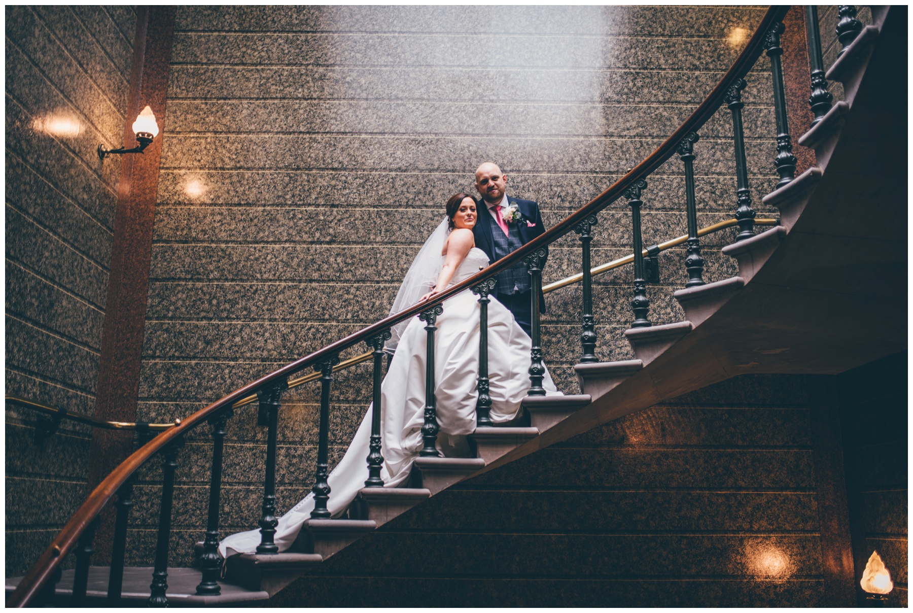 Bride and groom stand together in St George's Hall in Liverpool.