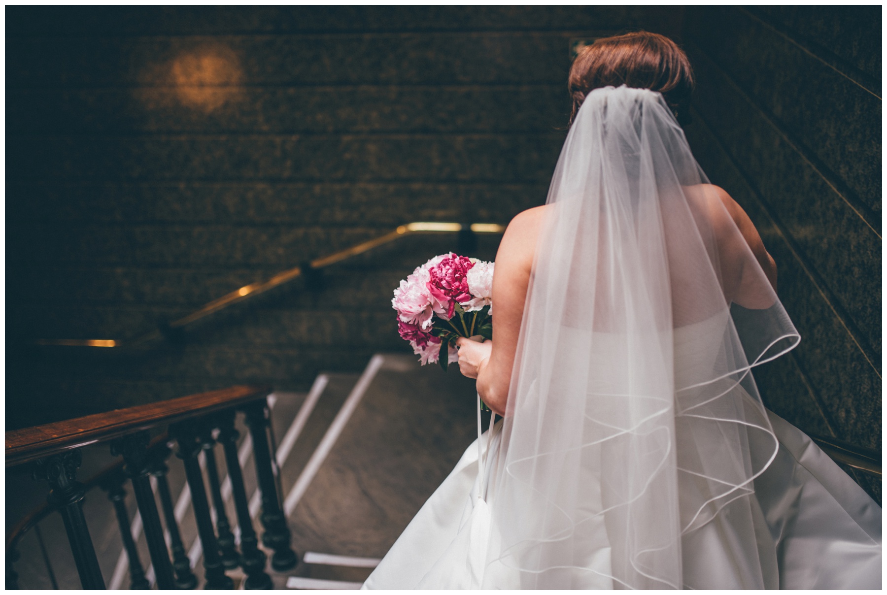 Bride and groom stand together in St George's Hall in Liverpool.