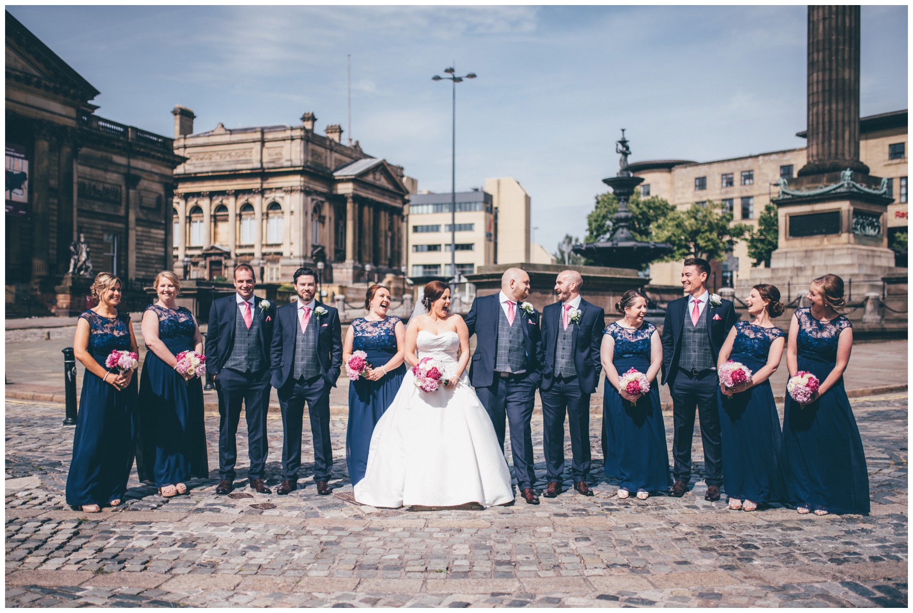 Bride, groom and Their bridal party all together outside St Georges Hall in Liverpool.