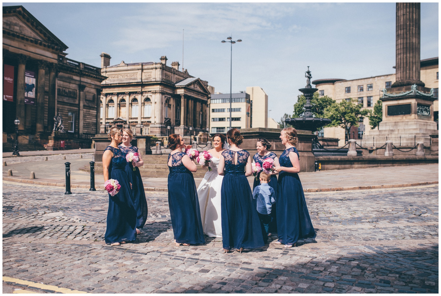 Bride and her bridesmaids all together outside St Georges Hall in Liverpool.
