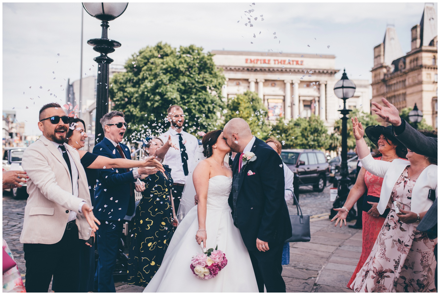 Confetti gets thrown at the bride and groom outside St Georges Hall in Liverpool.