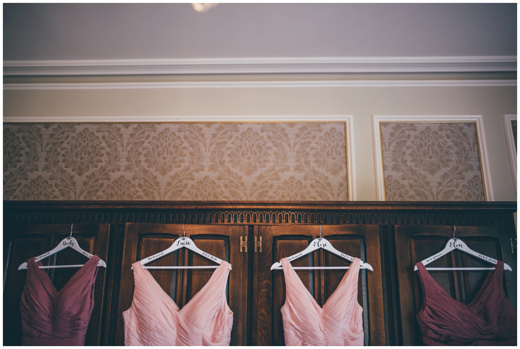 Bridesmaids dresses hung up in the bridal suite at Tilstone House in Cheshire.
