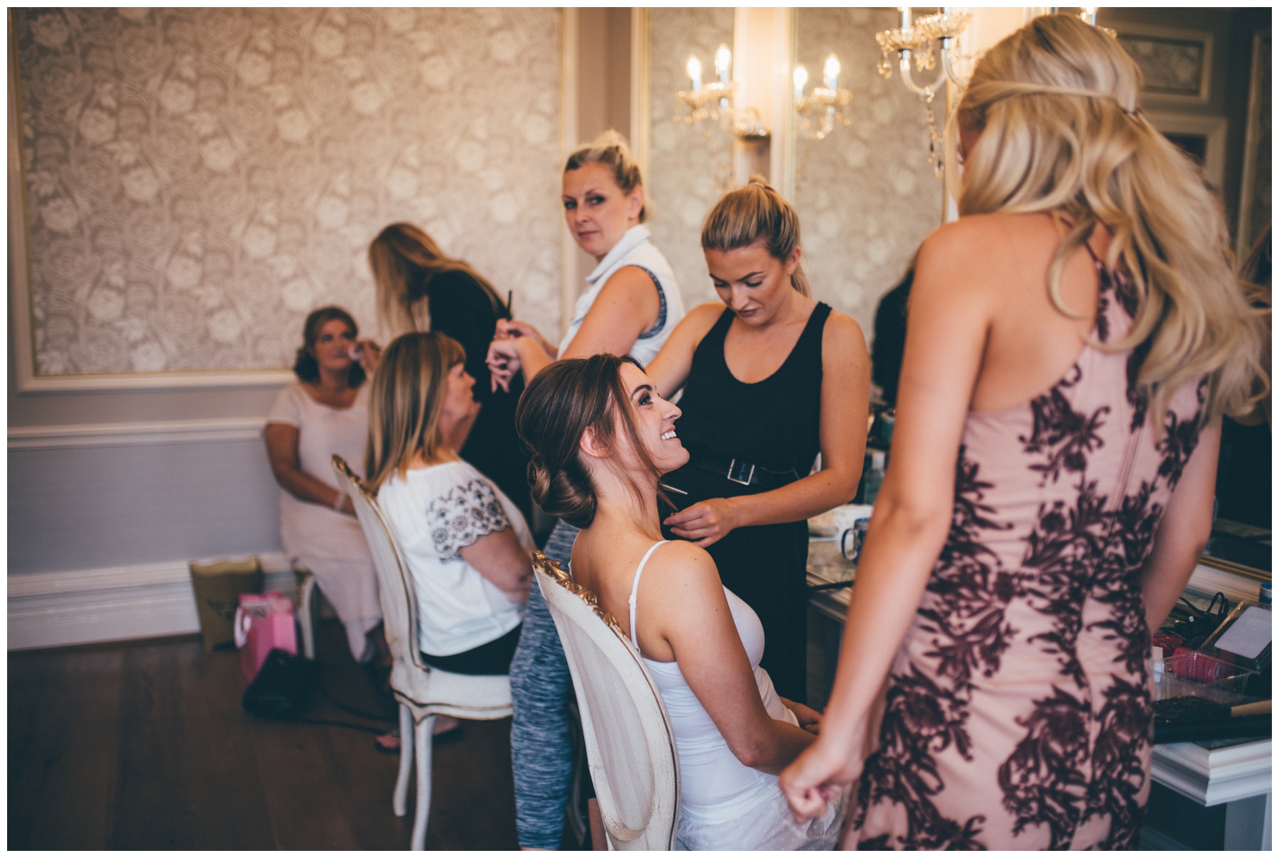 Beautiful bride getting her wedding make-up done in the bridal suite at Tilstone House in Tarporley, Cheshire.